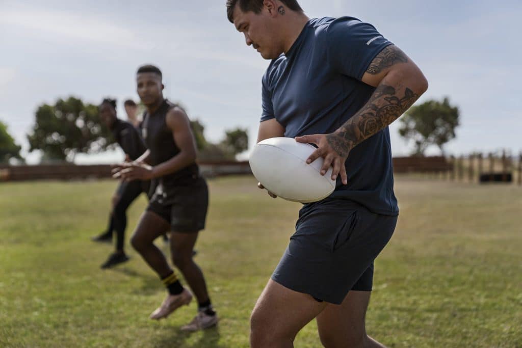 men playing rugby field men playing rugby field